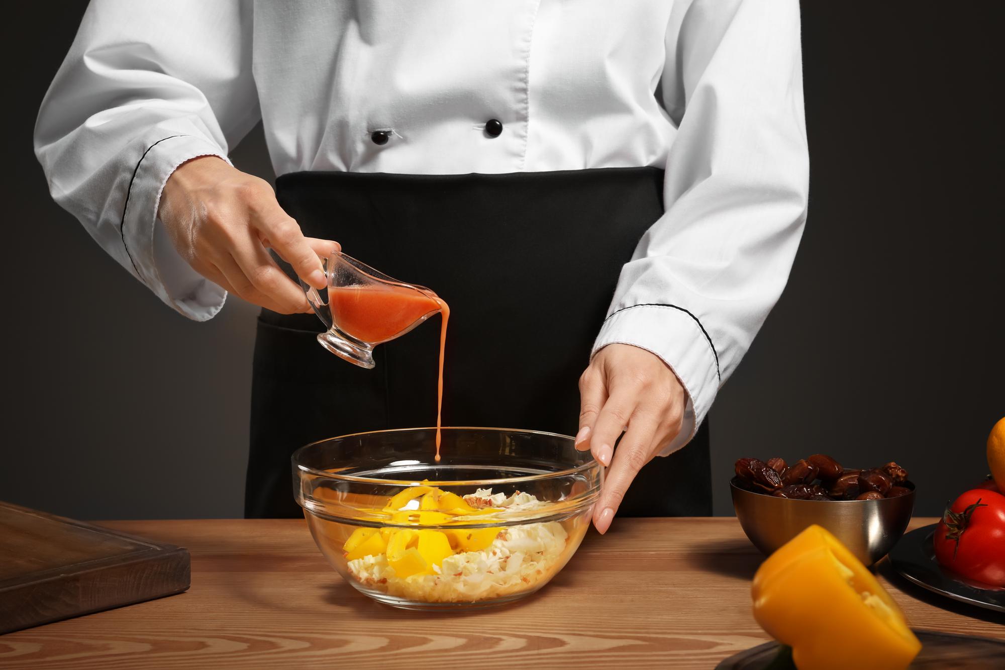 Chef demonstrating saucing technique